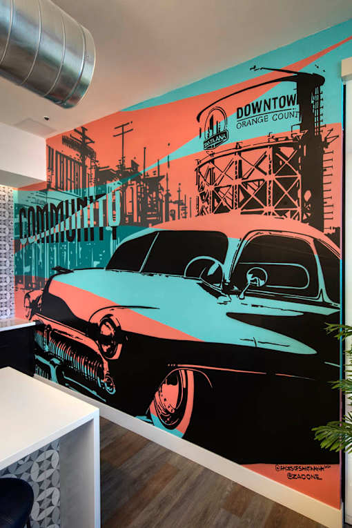 A Downtown Orange County mural with a black car in the foreground.