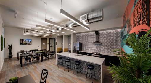 A modern office space with a bar area and seating.