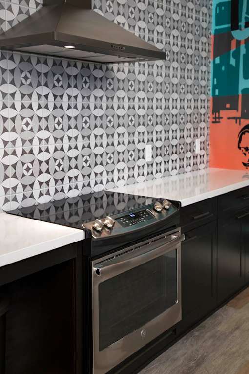 A kitchen with a black oven and a white countertop.