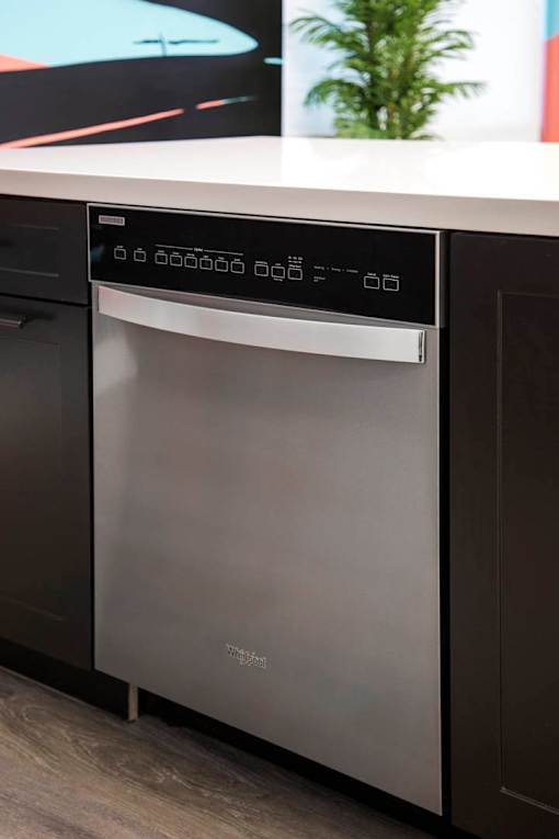A modern stainless steel dishwasher with a digital display panel.