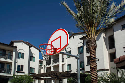A basketball hoop with a red and white sign on it.