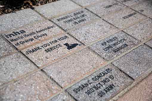 A brick with a plaque that says thank you for your service.