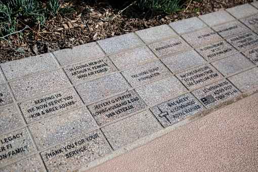 A memorial plaque with names and messages engraved on it.