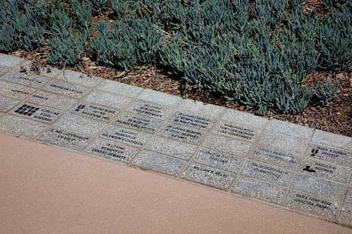 A memorial with names and images of people.