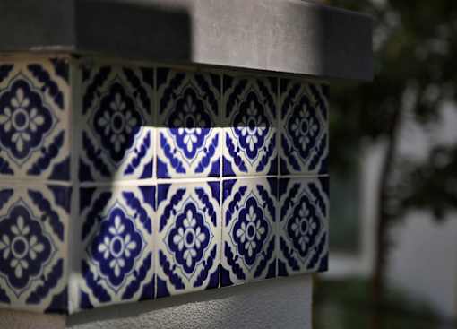 A close up of a blue and white tiled wall.