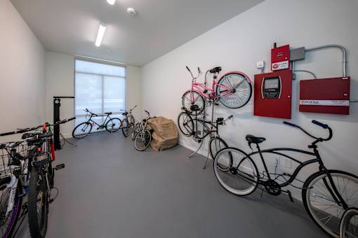 A bike parking room with a red box on the wall.