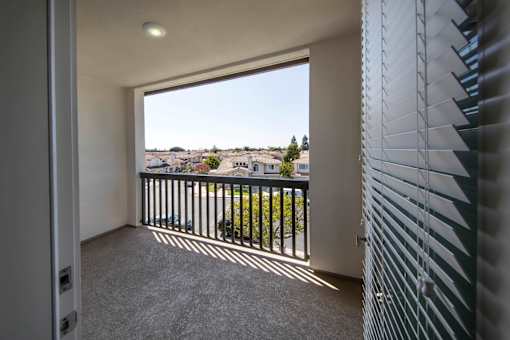 A balcony with a view of a residential area.