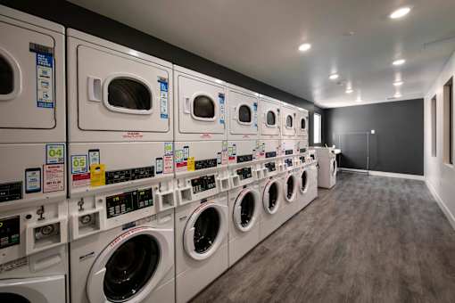 A row of washing machines in a laundromat.