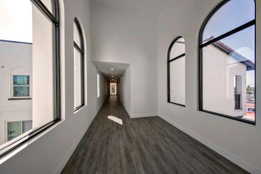 A long corridor with windows on both sides.