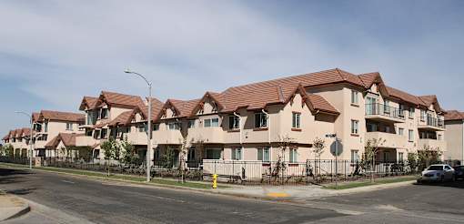 Apartment building with red roofs and white walls.