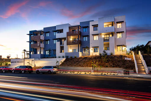 A modern building with a car parked in front of it.