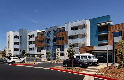 A modern building with a white van parked in front.