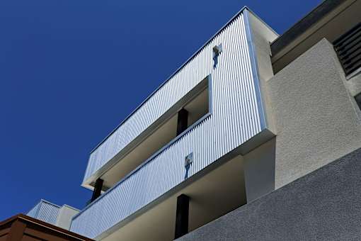 A modern building with a blue sky in the background.