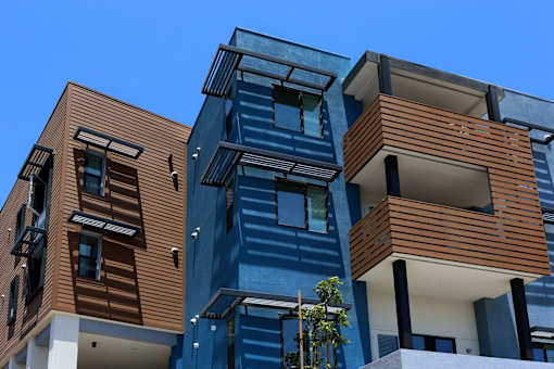 A modern multi-story building with blue and brown exterior.