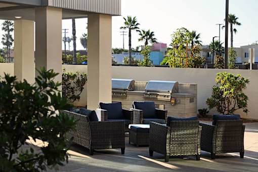 A patio with a couch, chairs and a table.
