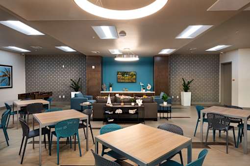 A modern dining area with tables and chairs.