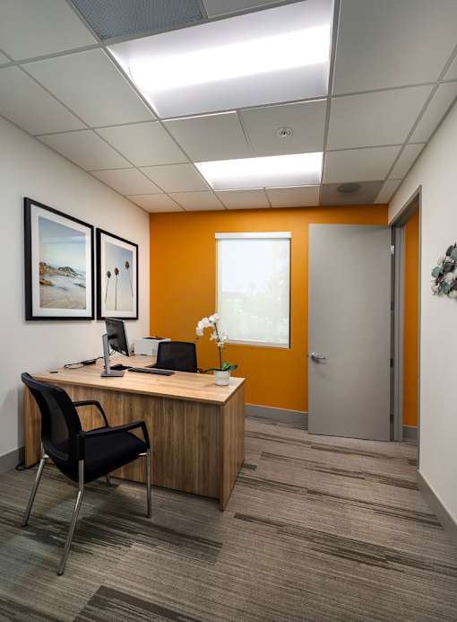 A room with a desk and chair.