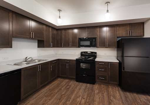 A kitchen with dark wood cabinets and appliances.