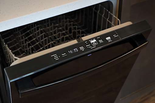 A black oven with a digital display and control panel.