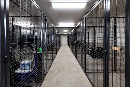 A long hallway with cages on both sides.