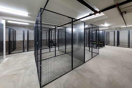 A large room with a black fence in the middle.