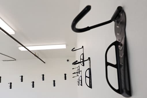 A black object is hanging on a white wall.