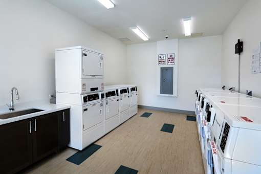 A laundry room with washers and dryers.