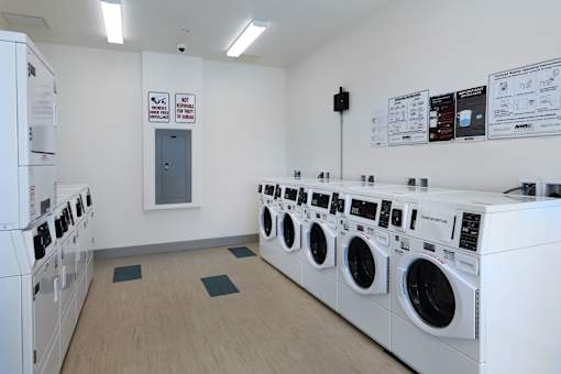 A row of washing machines in a laundromat.