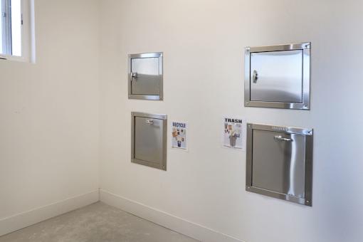Three metal framed mirrors are on a wall.