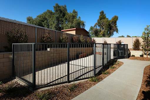 A black metal fence surrounds a building.