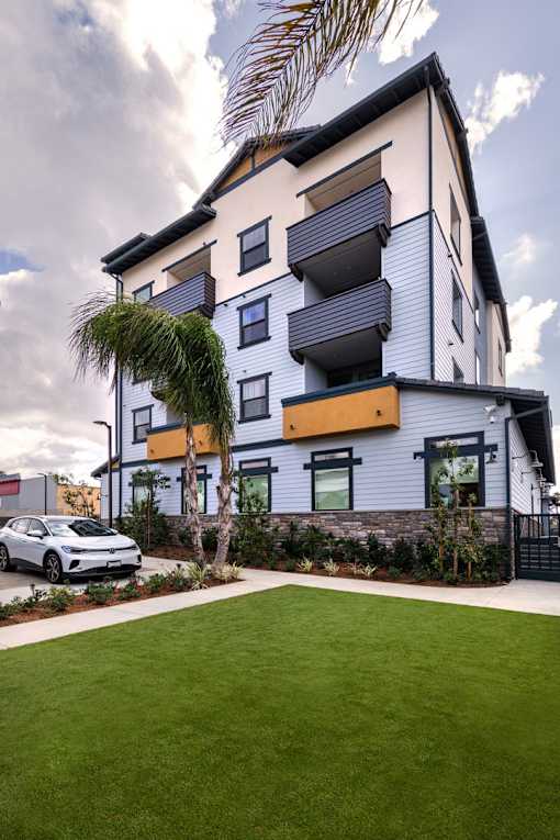 A modern two-story house with a car parked in front.