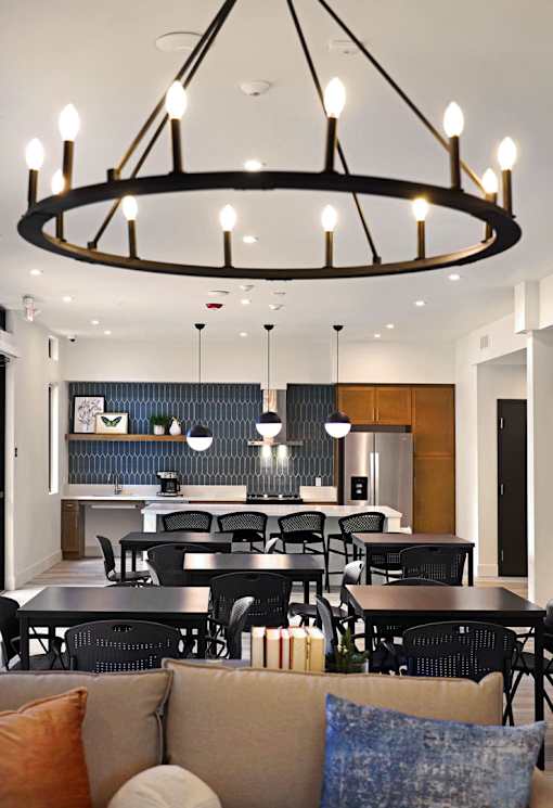 A modern dining room with a large table and chairs.