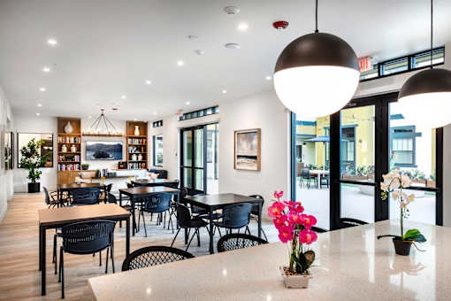 A modern dining area with a long table and chairs.