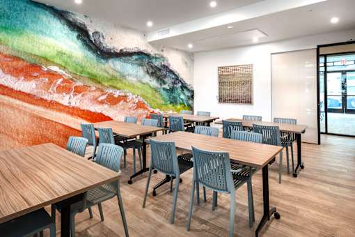 A conference room with a large table and chairs.