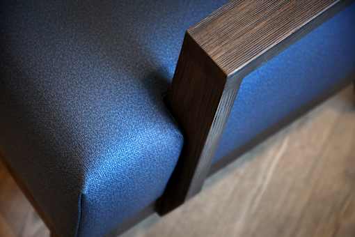 A close up of a wooden object with a blue fabric.