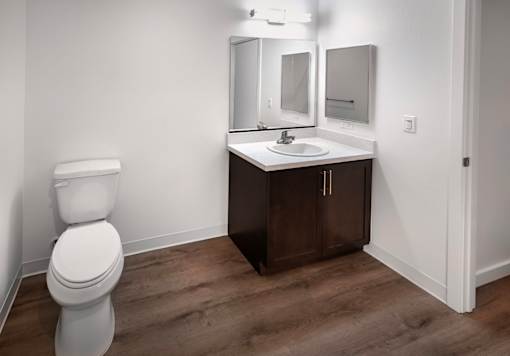 A white toilet sits next to a sink in a small bathroom.