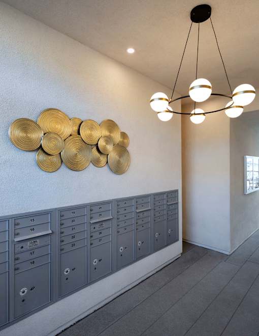 A wall of mailboxes with a row of gold circles above them.
