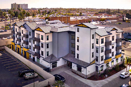 A parking lot in front of a building with a yellow stripe.