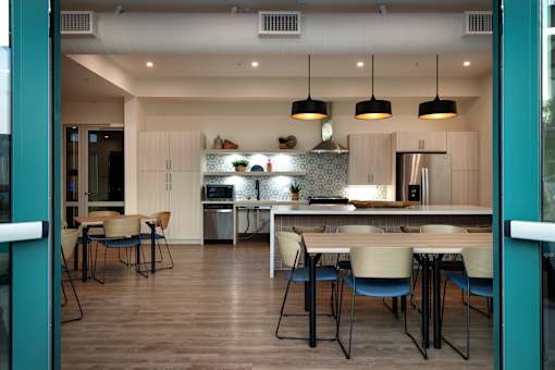A modern kitchen with a dining table and chairs.