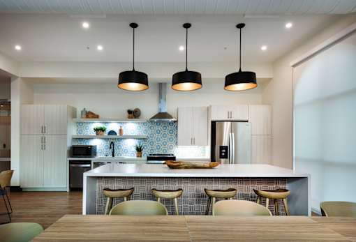 A modern kitchen with a dining table and chairs.