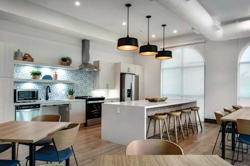 A modern kitchen with a dining table and chairs.