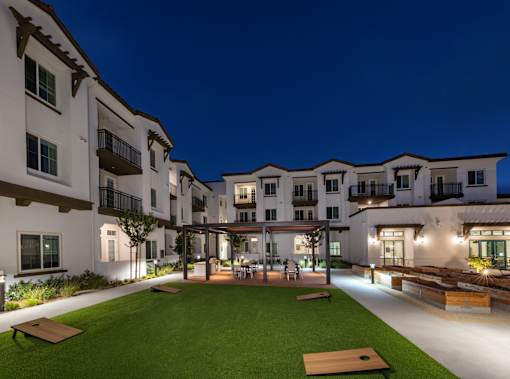 A well-lit outdoor area of a residential building at night.