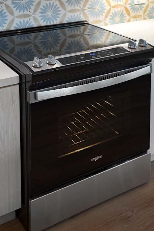 A modern oven with a stainless steel finish and a glass door.