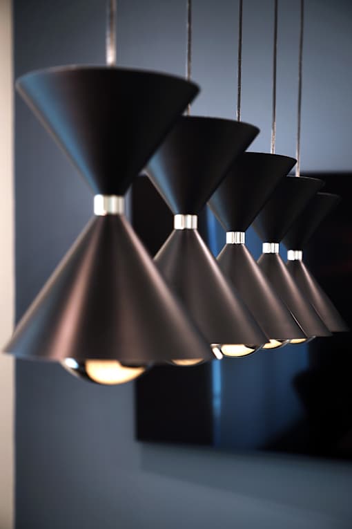A series of black pendant lights are suspended from the ceiling.
