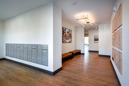 A long hallway with a bench and pictures on the wall.