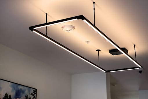A modern ceiling light fixture with a rectangular frame and a single light bulb.