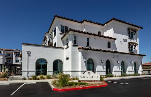 A white building with the name Salida del Sol on it.