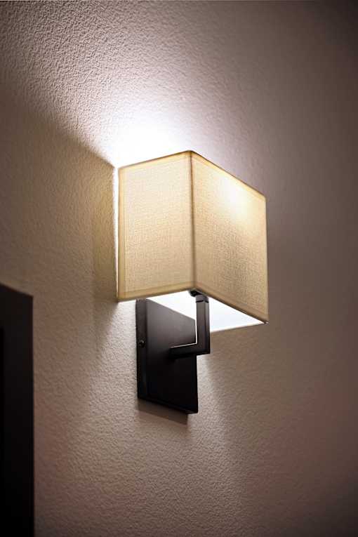 A wall-mounted lamp with a square shade and a rectangular base.