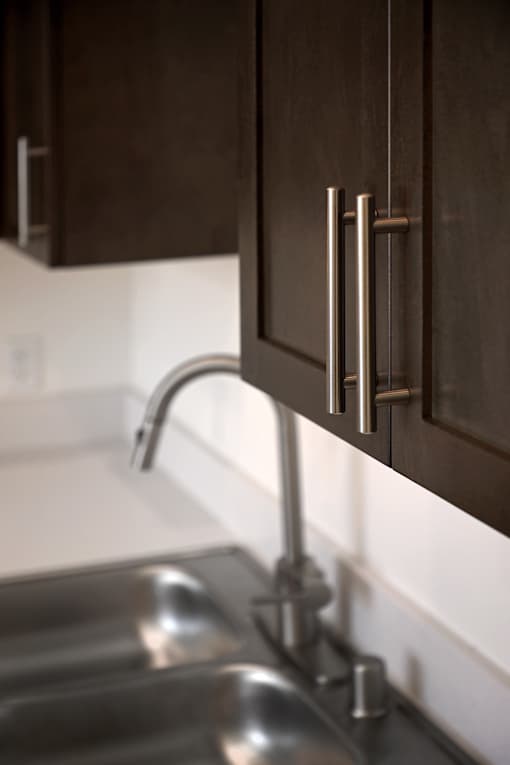 A close up of a kitchen sink with a chrome tap.