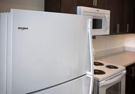 A white Whirlpool refrigerator in a kitchen.